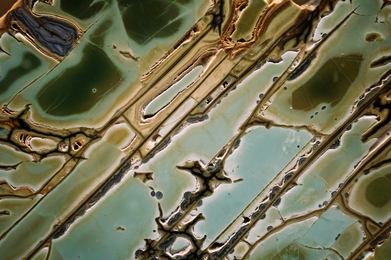 Intricate abstract green marble texture resembling natural geology formations.